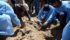 تفحص پیکر شهیدی با قمقمۀ پرازآب